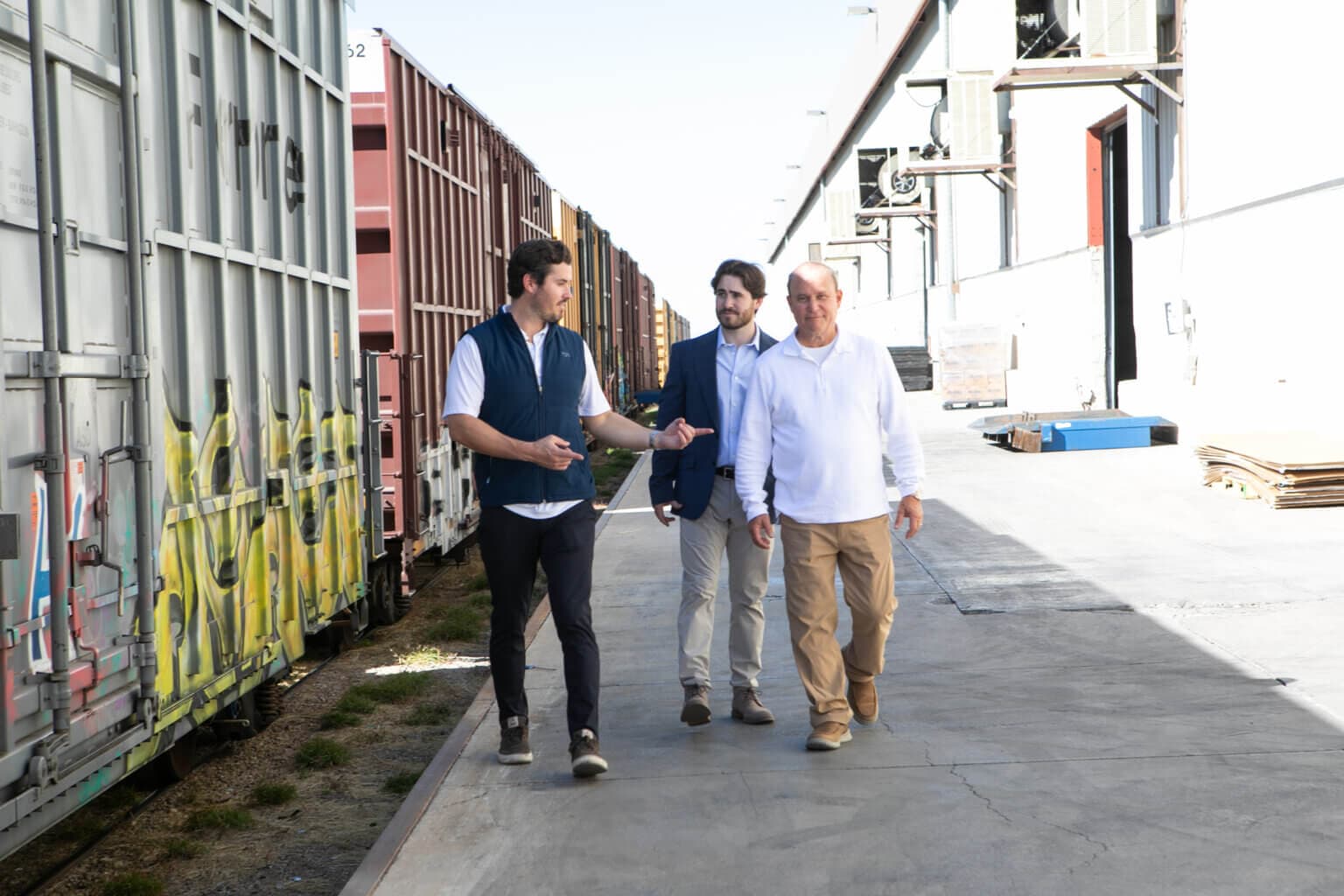 Team walking near a logistics train